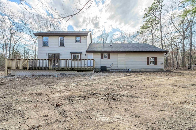 rear view of house featuring a deck and cooling unit