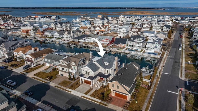 drone / aerial view with a water view and a residential view