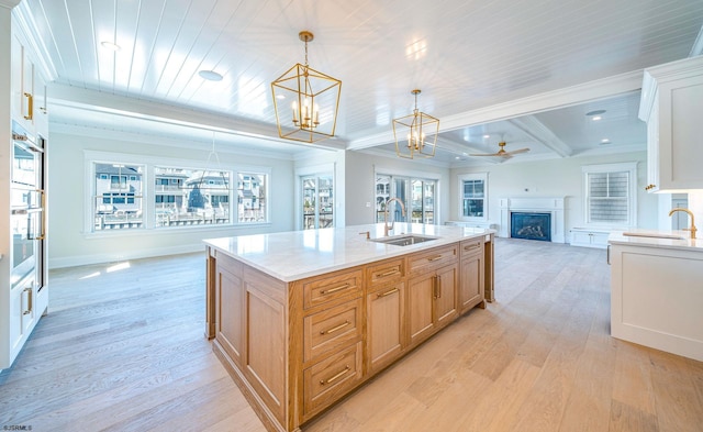 4 Grenada Ln, Ocean City, NJ 08226 - kitchen featuring light wood finished floors, a fireplace, open floor plan, and a sink