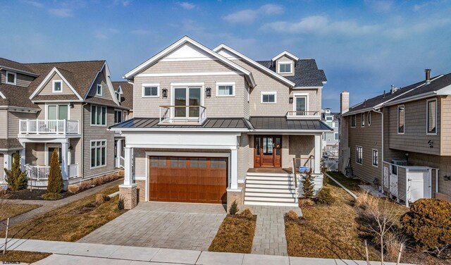 4 Grenada Ln, Ocean City, NJ 08226 - view of front facade with decorative driveway, a standing seam roof, metal roof, and a garage