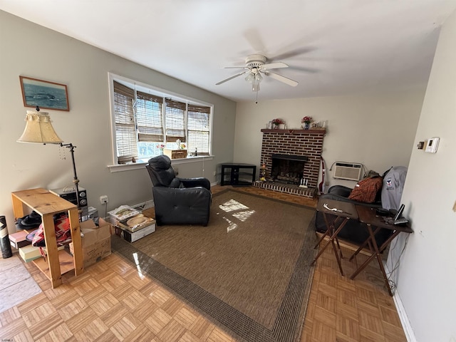 living area featuring a brick fireplace, a ceiling fan, and baseboards