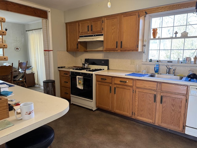 kitchen with light countertops, gas stove, a sink, dishwasher, and under cabinet range hood