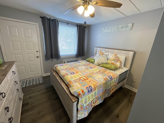 bedroom featuring a ceiling fan, dark wood finished floors, and baseboards