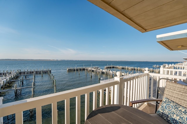 balcony featuring a water view and a boat dock