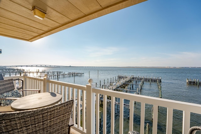 balcony with a boat dock and a water view