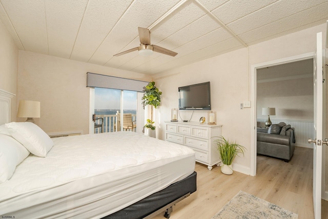 bedroom featuring access to outside, ceiling fan, and light wood finished floors