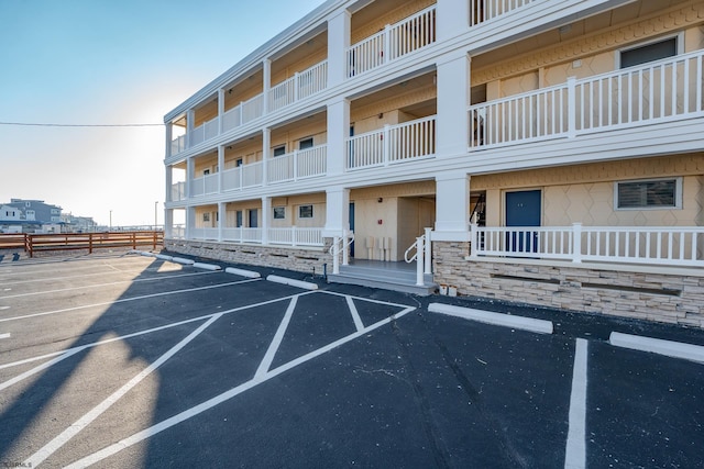 view of building exterior with uncovered parking