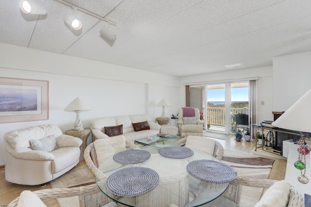 living area with a textured ceiling and wood finished floors