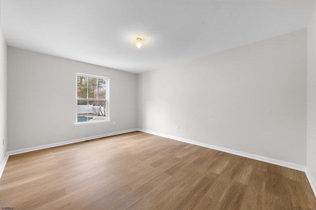 unfurnished room featuring light wood-style floors and baseboards