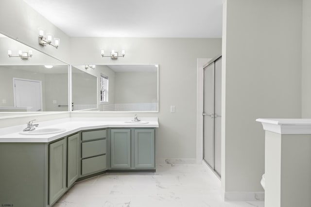 full bath featuring a stall shower, marble finish floor, and a sink