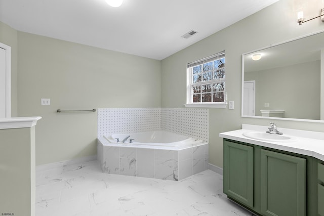 bathroom with visible vents, marble finish floor, vanity, and a bath