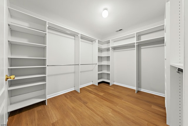 walk in closet with visible vents and wood finished floors
