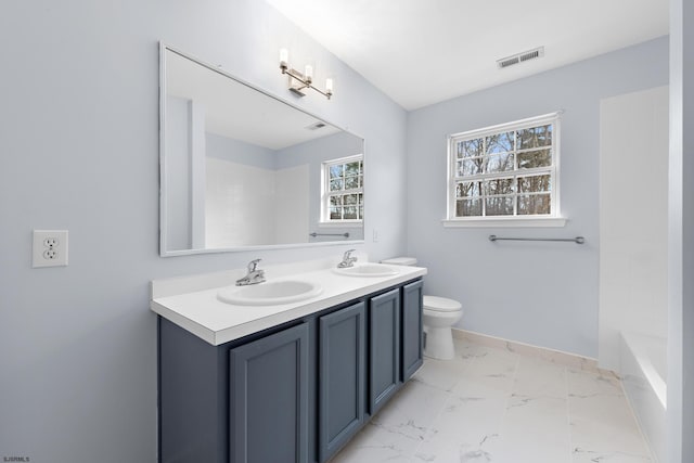 full bathroom featuring toilet, marble finish floor, visible vents, and a sink