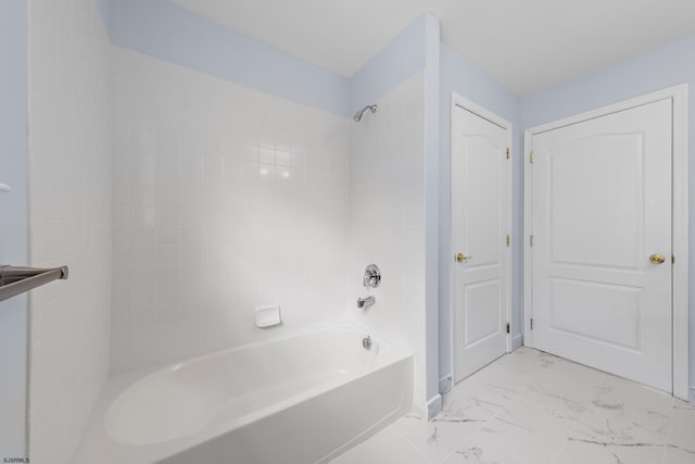 full bathroom featuring marble finish floor and shower / bath combination