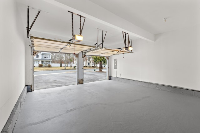 garage featuring a garage door opener and electric panel