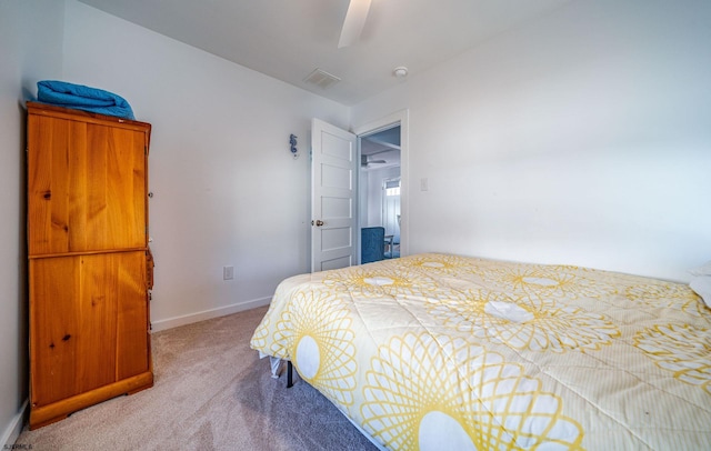 carpeted bedroom featuring a ceiling fan, visible vents, and baseboards