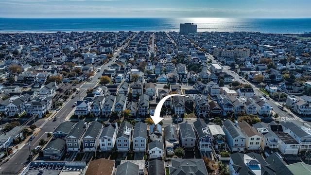 drone / aerial view featuring a residential view and a water view