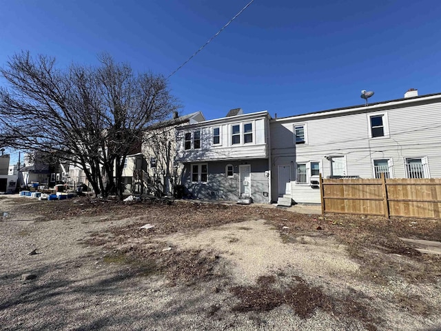 back of property featuring fence