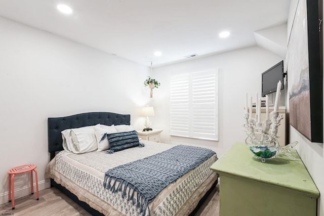 bedroom with recessed lighting, visible vents, baseboards, and wood finished floors