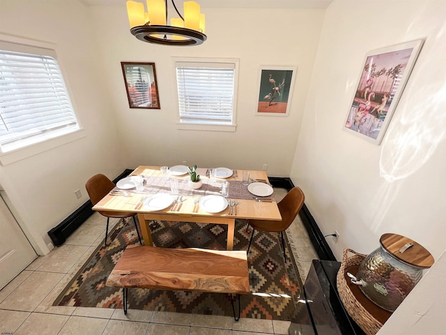 dining area with baseboards and tile patterned floors