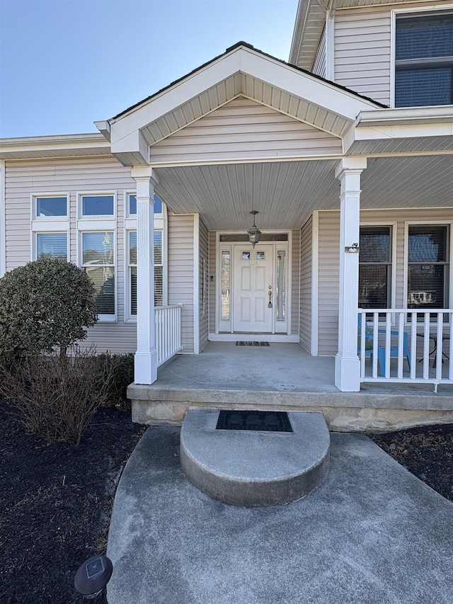 view of exterior entry with a porch