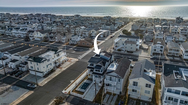 birds eye view of property featuring a water view and a residential view