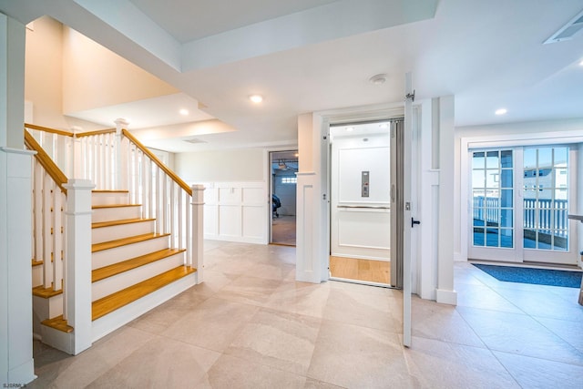 entryway with stairway, visible vents, and recessed lighting