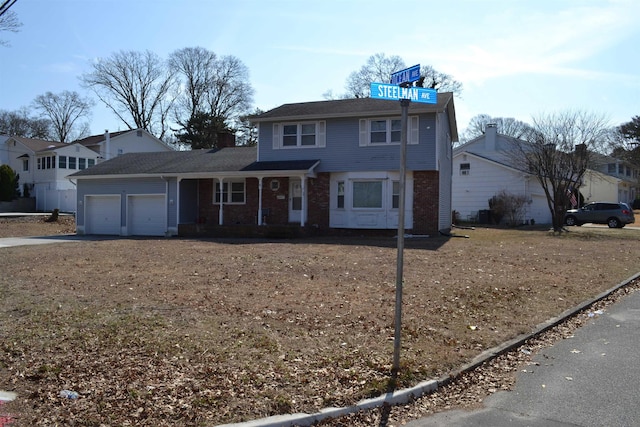 view of front facade featuring brick siding, driveway, and an attached garage