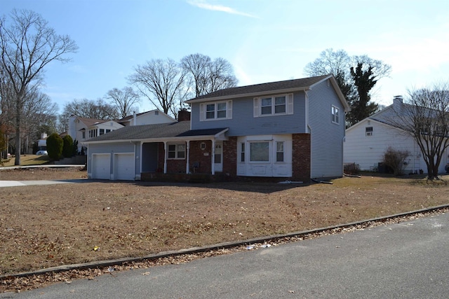 view of front facade featuring a garage and brick siding