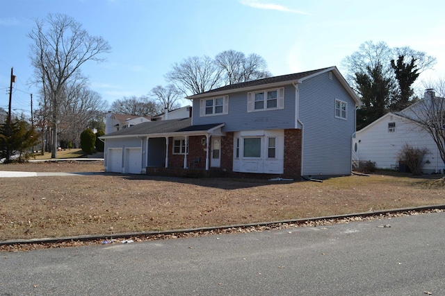 traditional-style home featuring aphalt driveway and an attached garage