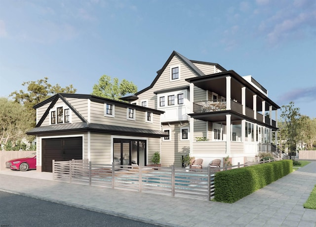 view of front facade featuring a garage, a balcony, metal roof, fence, and french doors