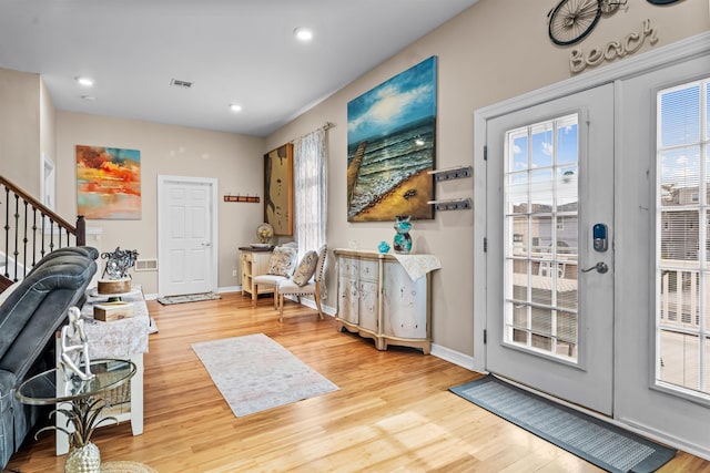 entryway with french doors, light wood-style flooring, visible vents, and baseboards