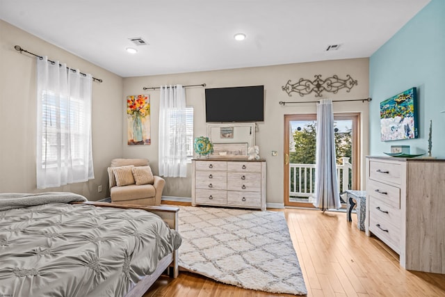 bedroom featuring light wood-style floors, visible vents, and access to exterior