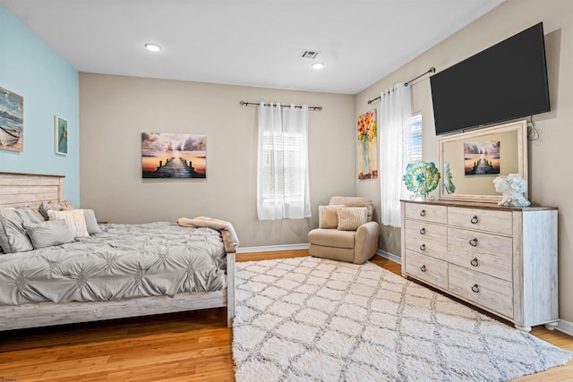 bedroom featuring recessed lighting, visible vents, baseboards, and wood finished floors