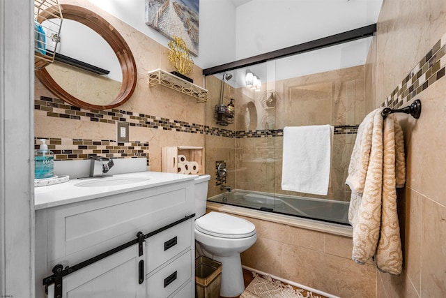 bathroom with enclosed tub / shower combo, toilet, vanity, tile walls, and decorative backsplash