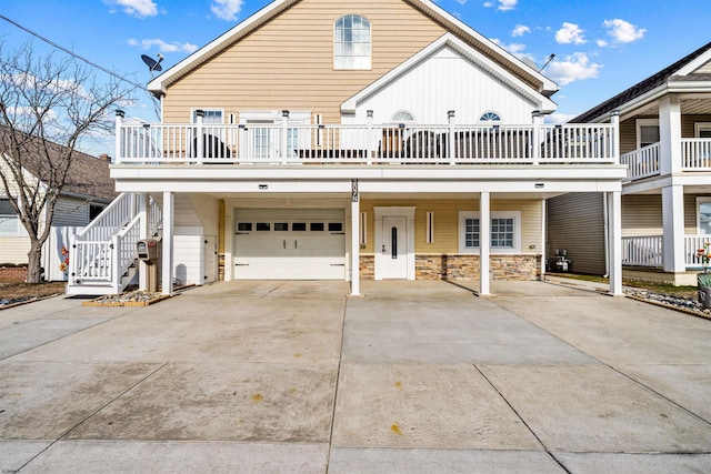 view of front facade featuring an attached garage, stairs, and concrete driveway