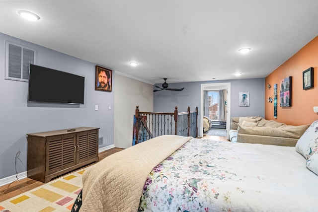 bedroom featuring recessed lighting, wood finished floors, visible vents, and baseboards