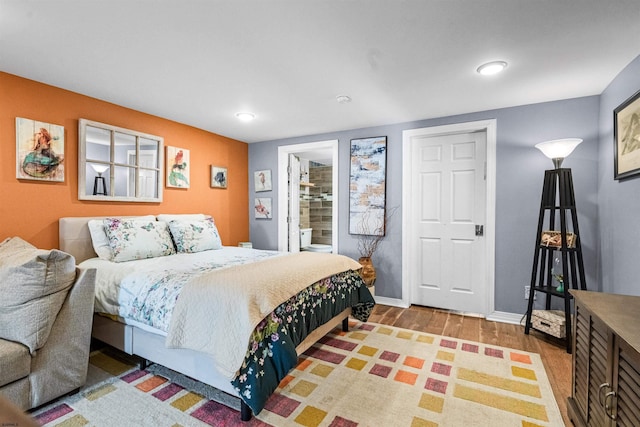 bedroom featuring wood finished floors and baseboards