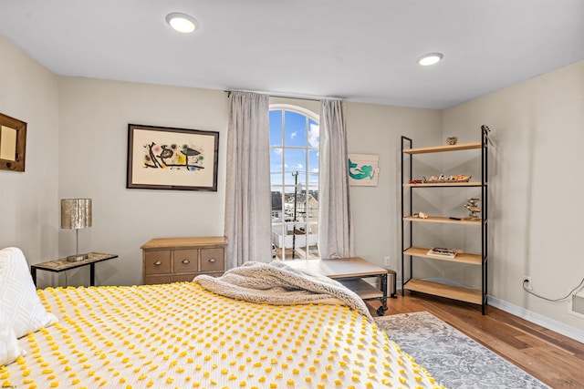 bedroom with recessed lighting, wood finished floors, and baseboards