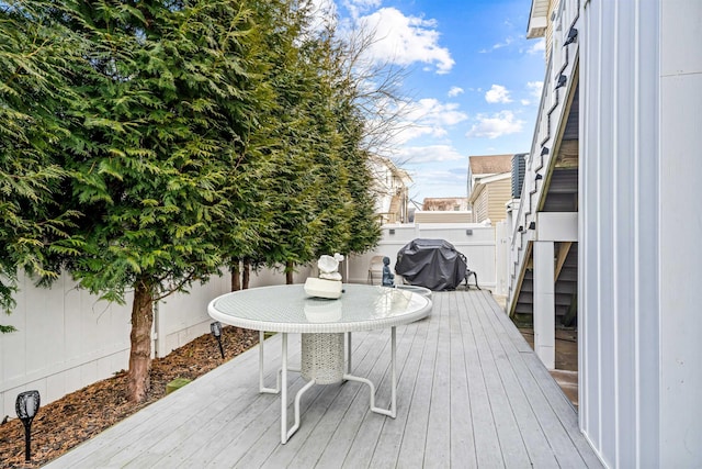 wooden deck featuring a fenced backyard and grilling area