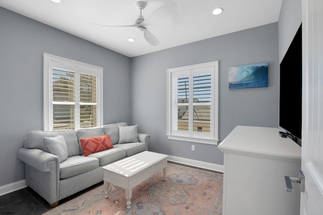 living area with ceiling fan, baseboards, and recessed lighting