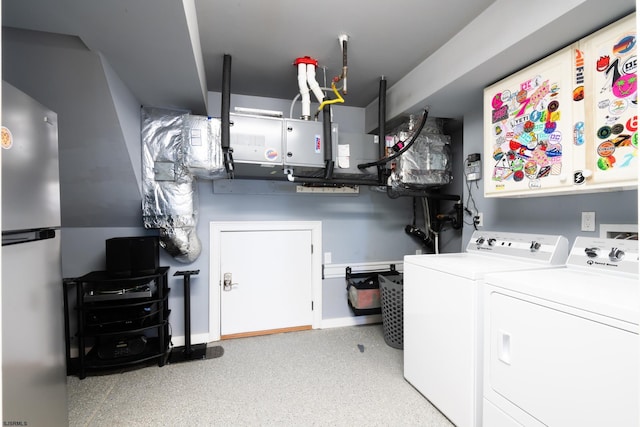 laundry area with washer and dryer, laundry area, and baseboards