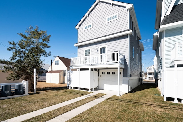 view of front of property featuring a front yard, an outbuilding, an attached garage, and a storage unit