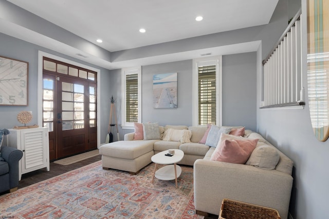 living room with recessed lighting, visible vents, and wood finished floors