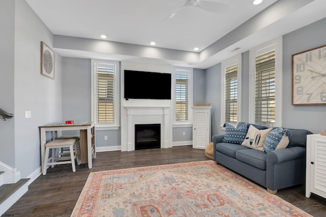 living area with recessed lighting, wood finished floors, a ceiling fan, and baseboards