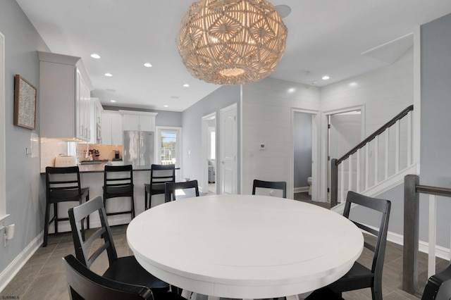 dining area featuring recessed lighting, stairway, baseboards, and an inviting chandelier