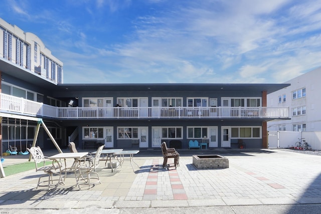 exterior space featuring a patio area and a fire pit