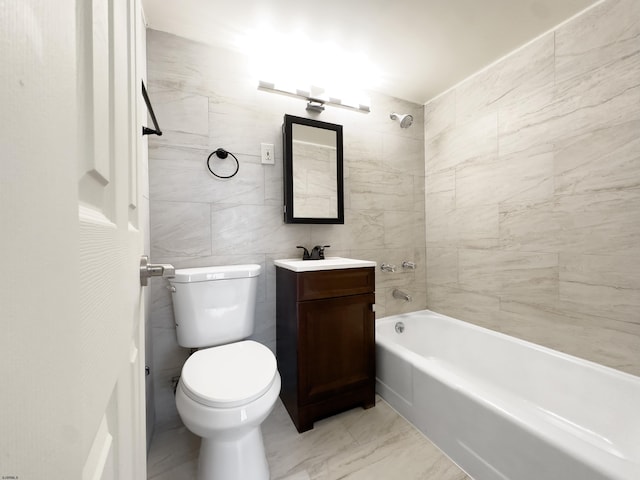 bathroom featuring bathing tub / shower combination, toilet, marble finish floor, vanity, and tile walls