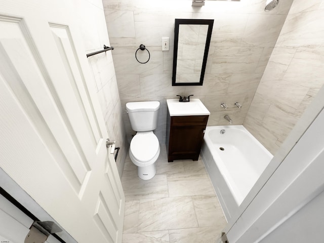 full bathroom with toilet, vanity, tile walls, marble finish floor, and  shower combination