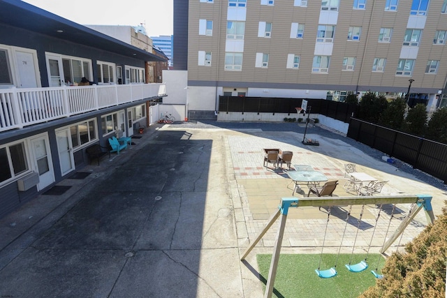 surrounding community featuring a patio and fence